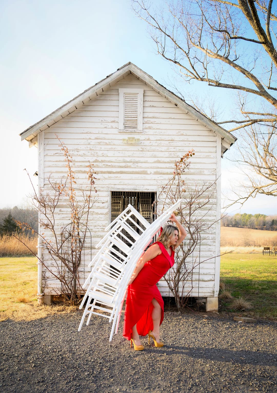 Isadora Martin-Dye carrying Chiavari chairs at Rixey Manor